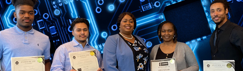 Edwin Hernandez (Youth Cybersecurity Analyst), Photo left to right: Zion Felton (Youth IT Specialist), Edwin Hernandez (Youth Cybersecurity Analyst), Ashley Felton (Owner), Shekela Patterson (Cybersecurity Analyst), Tarik Harley (Cybersecurity Analyst). 